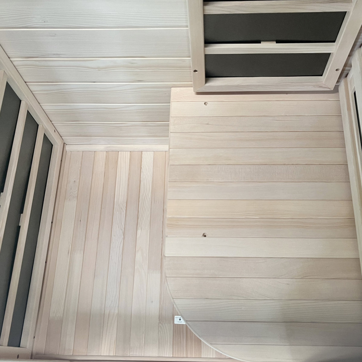 Slatted hemlock floor and bench inside the 1-person infrared sauna